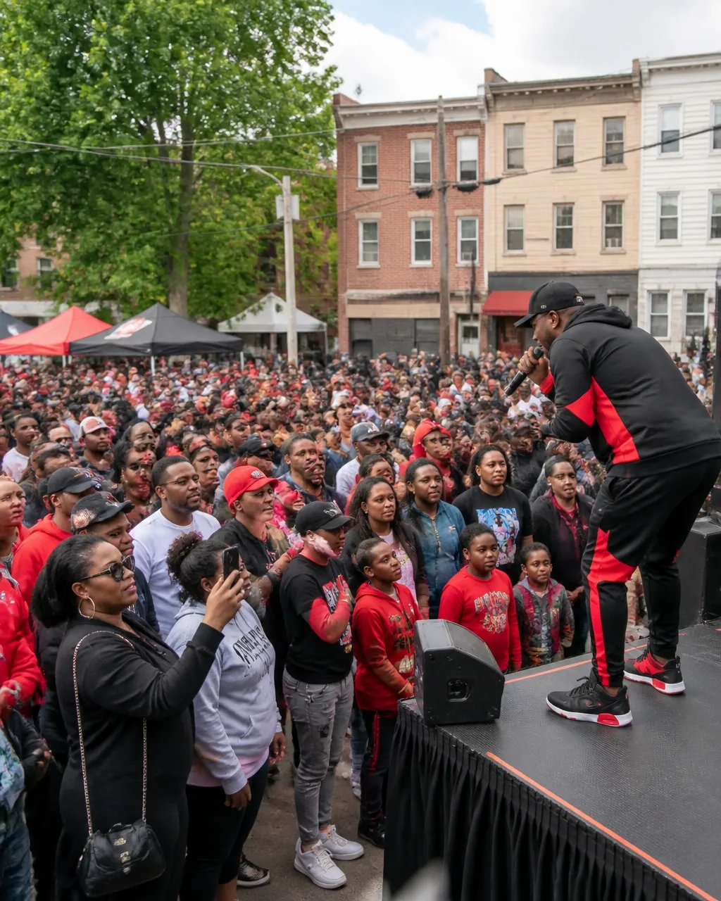 A diverse Newark community gathering together during an outdoor peace and music event