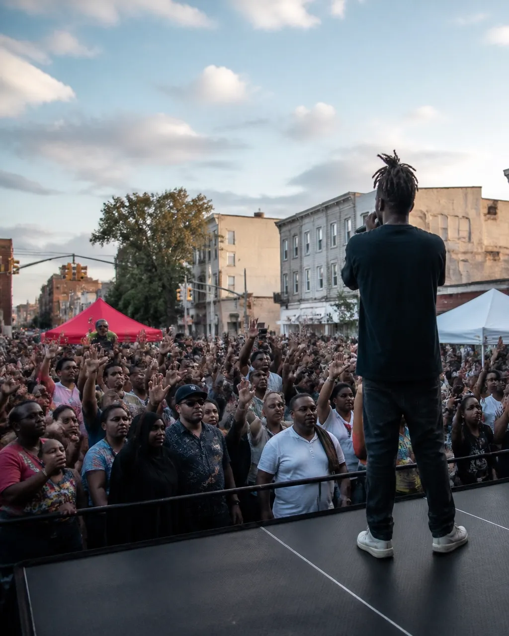 A distant spoken-word performance at a peaceful Newark community gathering